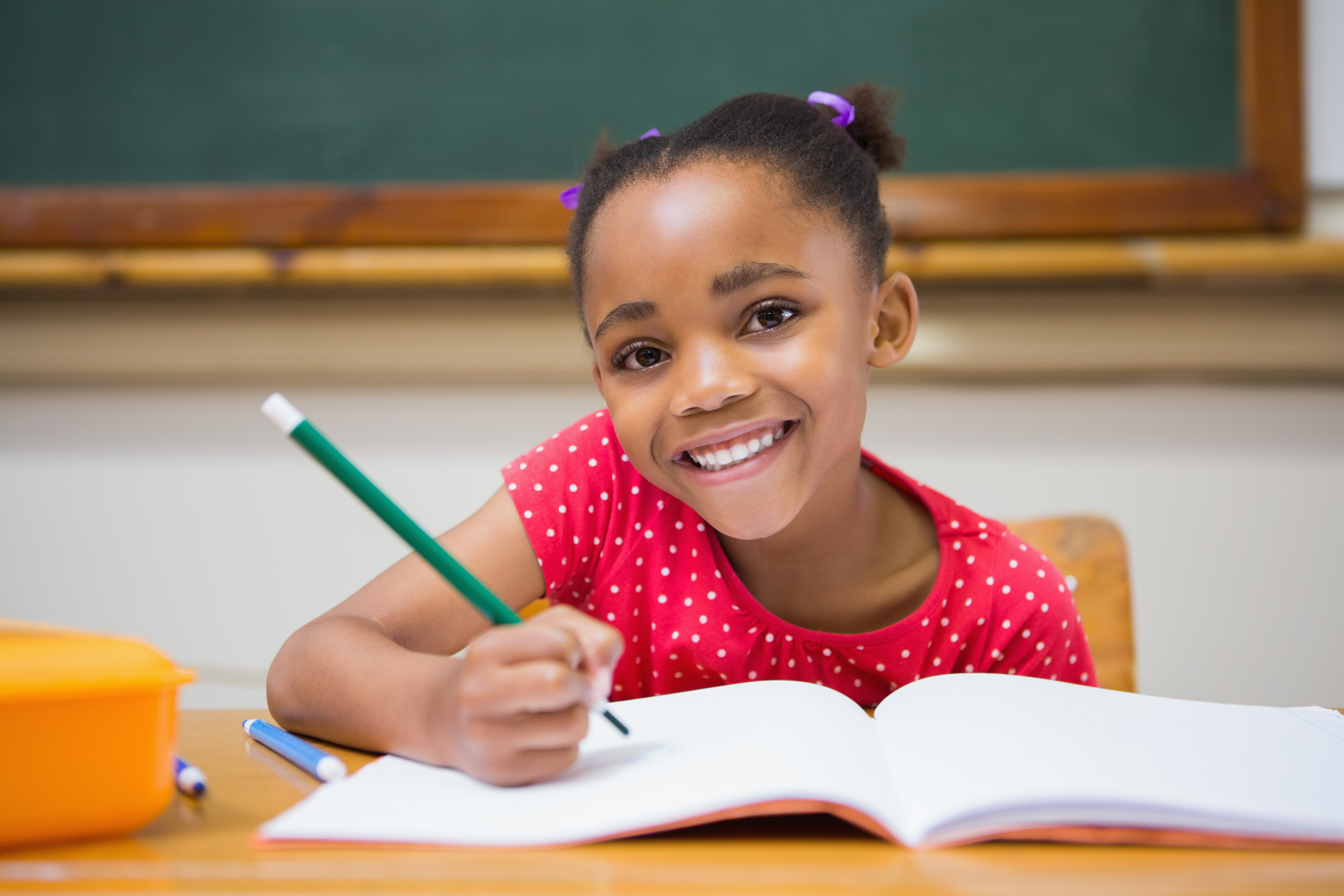 Cute,Pupils,Writing,At,Desk,In,Classroom,At,The,Elementary
