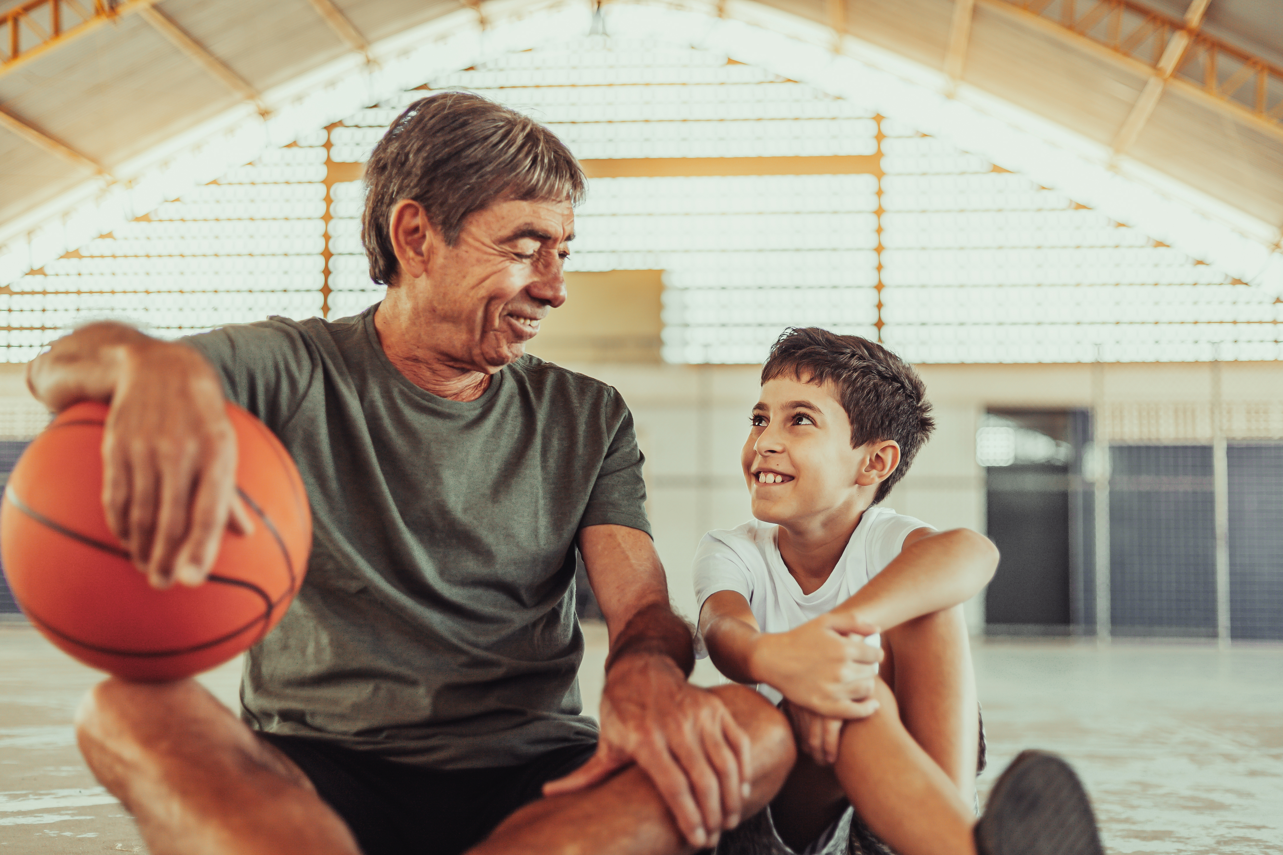 Latin,Grandfather,And,Grandson,Playing,Basketball,On,The,Court